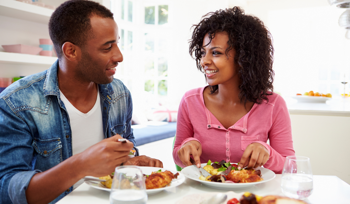 Two people eating dinner together