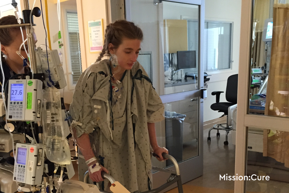Amanda using a walker at the hospital after TPIAT procedure.